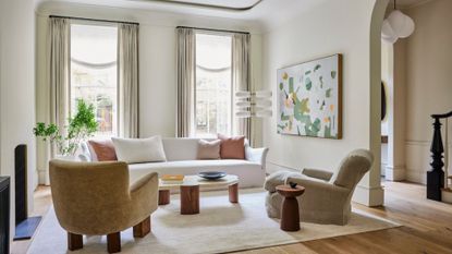 A clean home with accent chairs and a white sofa 