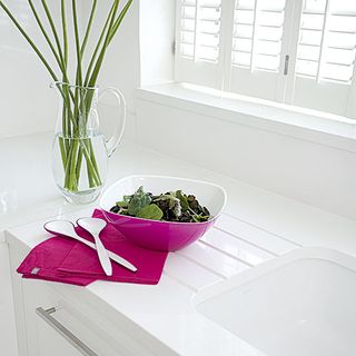kitchen area with white worktop and bowl with napkins