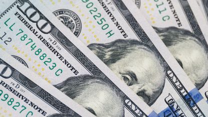 A fan of four $100 notes
