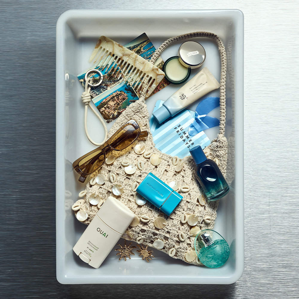 A photo of an airport tray filled with beauty products and accessories