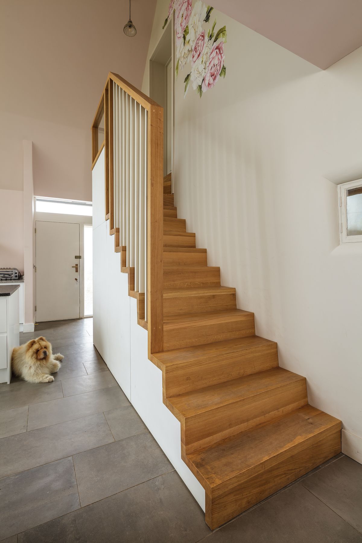 Extra storage under the stairs has been finished to match the kitchen cabinets.