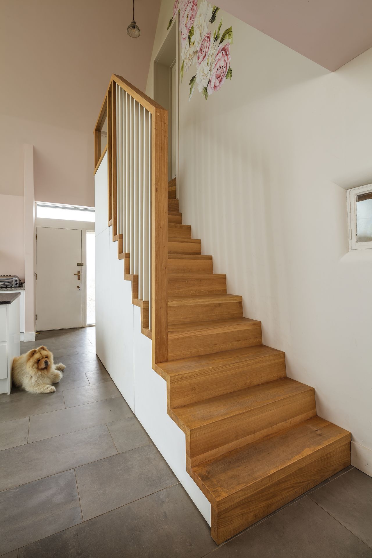 Extra storage under the stairs has been finished to match the kitchen cabinets.