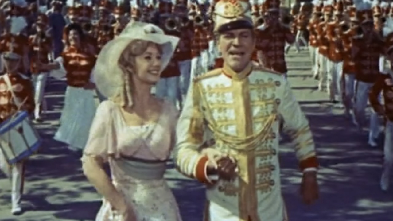 Marion and Harold Hill walking down the street in the Music Man