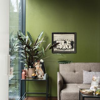 hallway with green wall and sofa