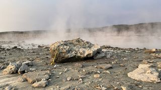 rock next to steaming pool after explosion in Yellowstone National Park