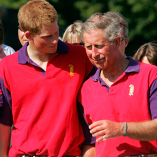 Prince Harry and Prince Charles share a joke at the presentation following the Highgrove Polo Team match against Laird polo team in the St James Place charity polo match at Beaufort Polo Club on July 16, 2005 in Tetbury, England.