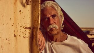 Sam Elliott in Landman, leaning against a post. 