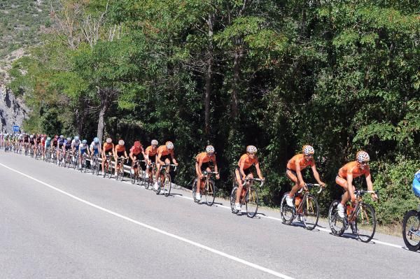 The peloton is lined out in pursuit of the break
