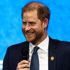 Prince Harry smiles while holding a microphone at the the Clinton Global Initiative in New York on September 24, 2024