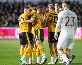 Bryn Morris celebrates with his Newport County team-mates after scoring against Manchester United in the FA Cup in January 2024.