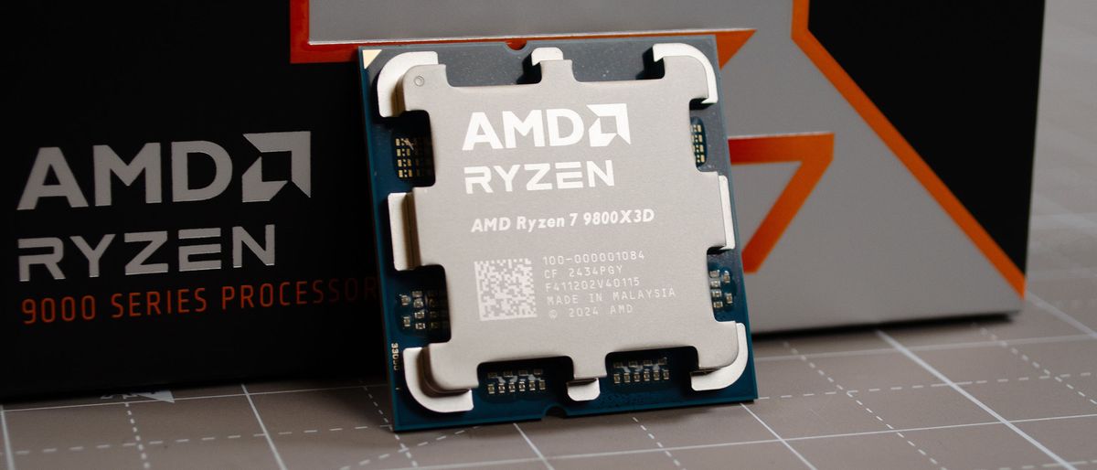 An AMD Ryzen 7 9800X3D on a desk against its retail packaging