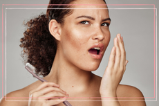 A women holding up her hand and testing her breathe