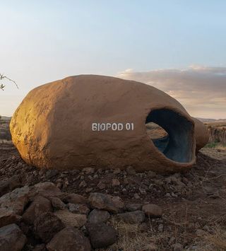 Earthy biopod as part of experimental student shelter project in the desert