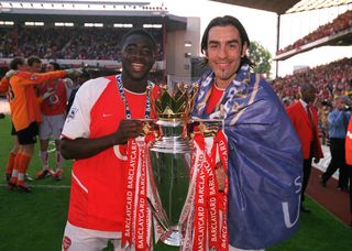 Kolo Toure and Robert Pires of Arsenal with the Premier League Trophy after the Premier League match between Arsenal and Leicester City on May 15, 2004 in London, England.