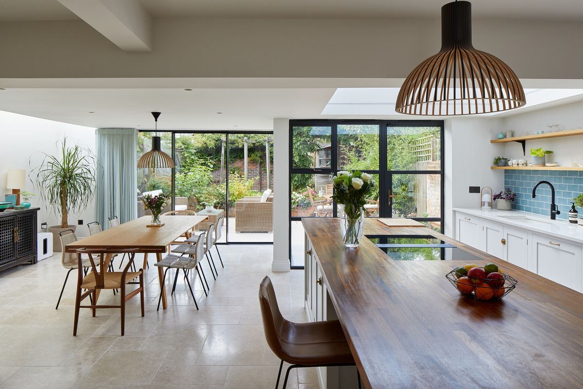 open plan white kitchen extension with steel doors