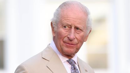 King Charles III speaks during a reception in the garden of Government House on May 1, 2026