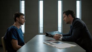 Devon Graye as Julian La Cosse and Manuel Garcia-Rulfo as Mickey Haller in an interviewing room in The Lincoln Lawyer season 3 episode 1