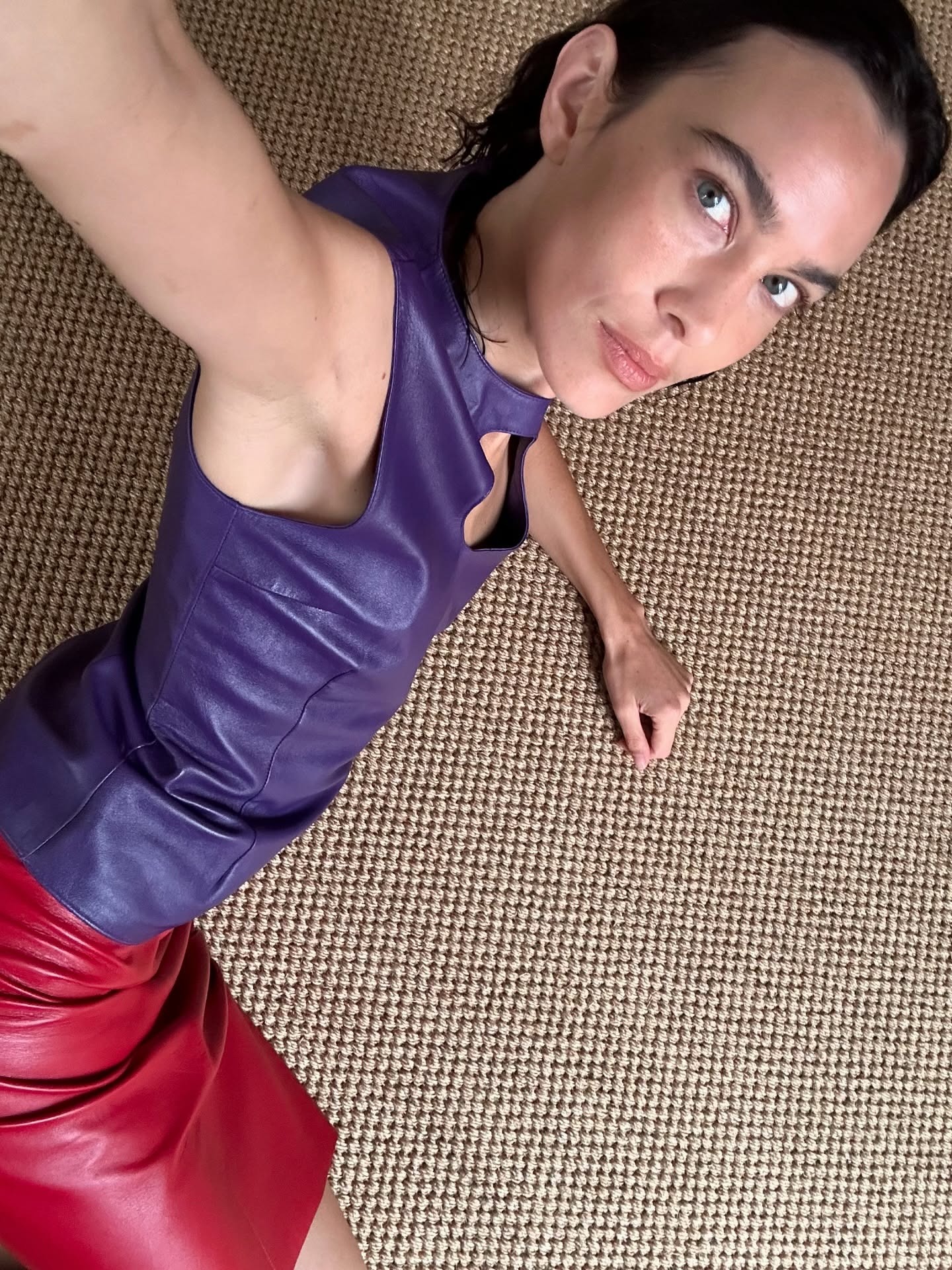 Alexa Chung wearing a purple top taking a selfie