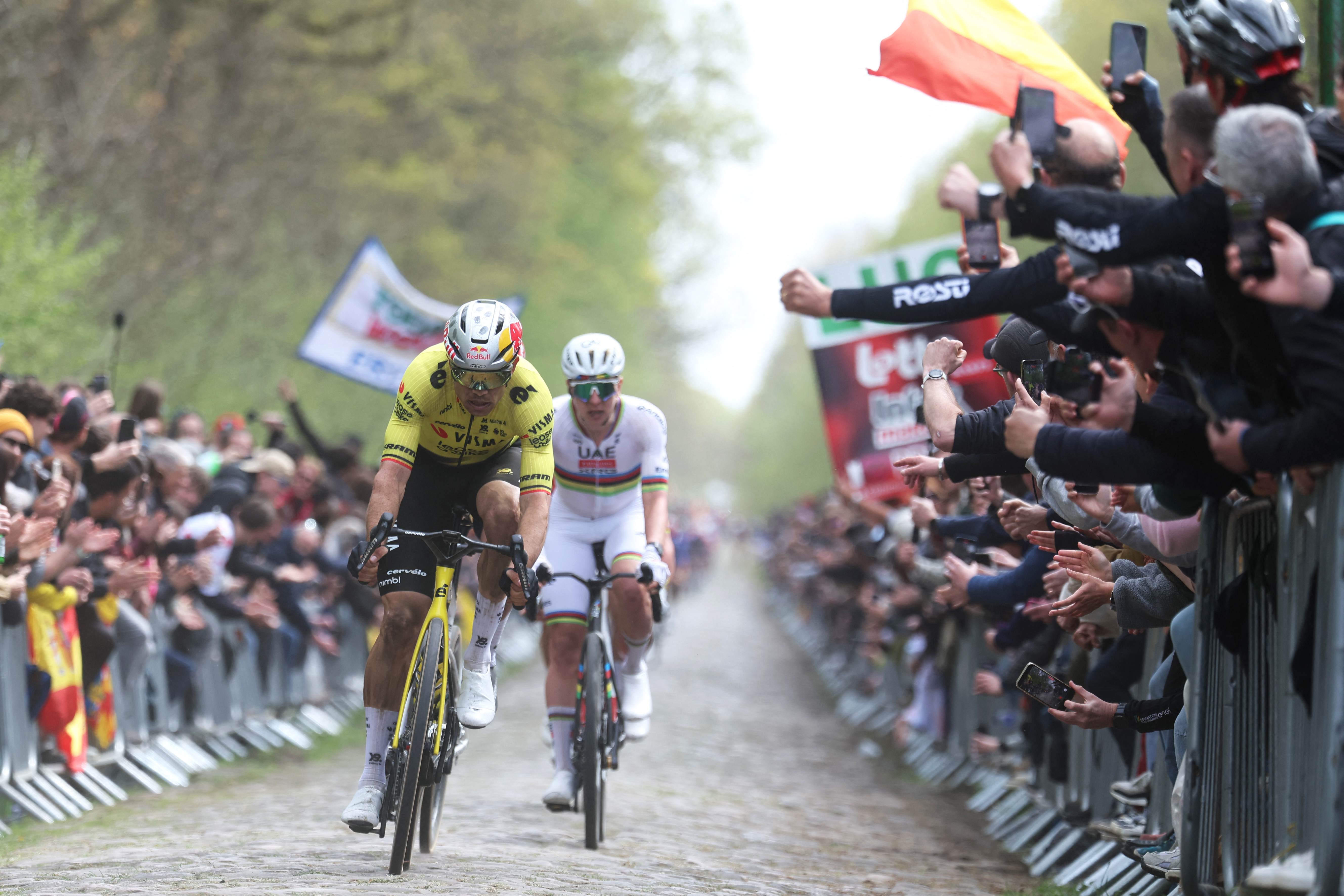 Team Visma - Lease a Bike's Belgian rider Wout van Aert (L) and UAE Team Emirates XRG's Slovenian rider Tadej Pogacar leave the 'Trou&eacute;e d&rsquo;Arenberg' cobblestone sector (Arenberg trench) during the 123rd edition of the Paris-Roubaix one-day classic cycling race, 258.3 km between Compi&egrave;gne and Roubaix, northern France, on April 12, 2026. (Photo by Francois LO PRESTI / AFP)