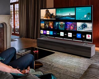 LG NANO90 85-inch TV being viewed by father and son in lounge area