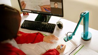 Person using a document camera on desk