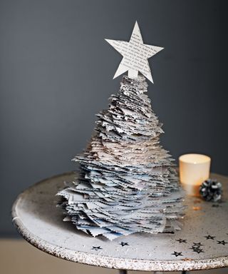 Small paper christmas tree on table