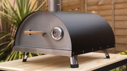Woody pizza oven on a wooden table