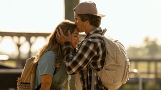A boy kisses a girl on the forehead