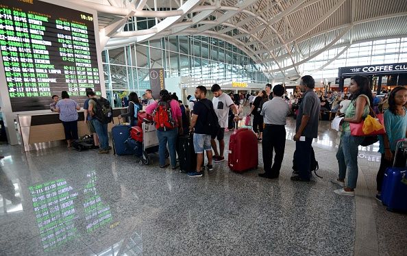 Travelers inside of an airport.