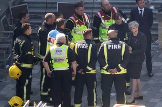 LONDON, ENGLAND - JUNE 15:Prime Minister Theresa May speaks to Dany Cotton, Commissioner of the London Fire Brigade, with members of the fire service as she visits Grenfell Tower, on June 15,