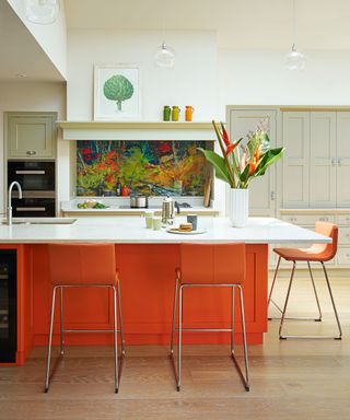 Orange kitchen island with neutral units by Martin Moore