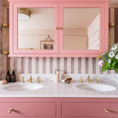 double basin with pink cabinet, underneath mirrored cabinet in matching pink