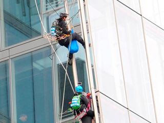 Female Greenpeace protestors climb the shard