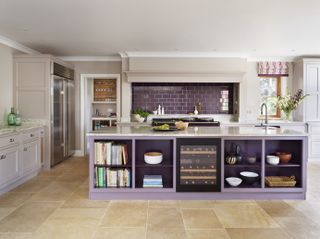 purple kitchen with painted island, purple tiled splash back, stone floor, wine cooler, kitchen blind