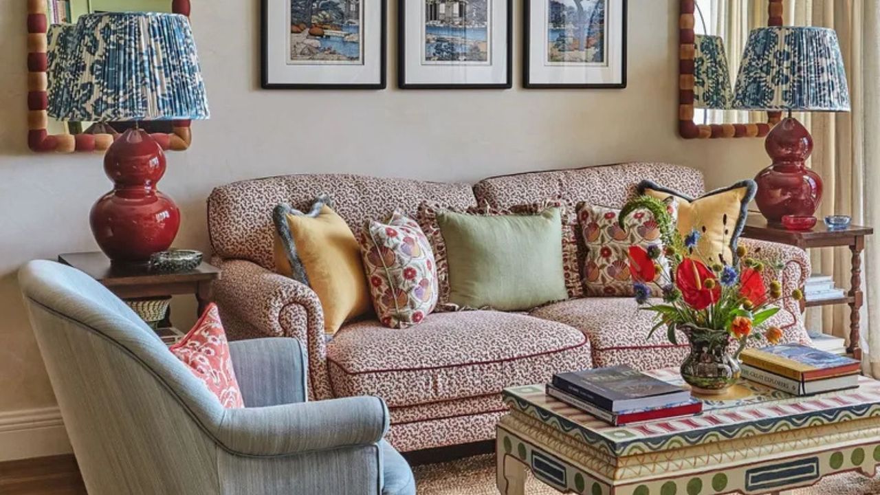 Colorful living room with pattern red and white couch, red and blue lamps and folk art painted coffee table