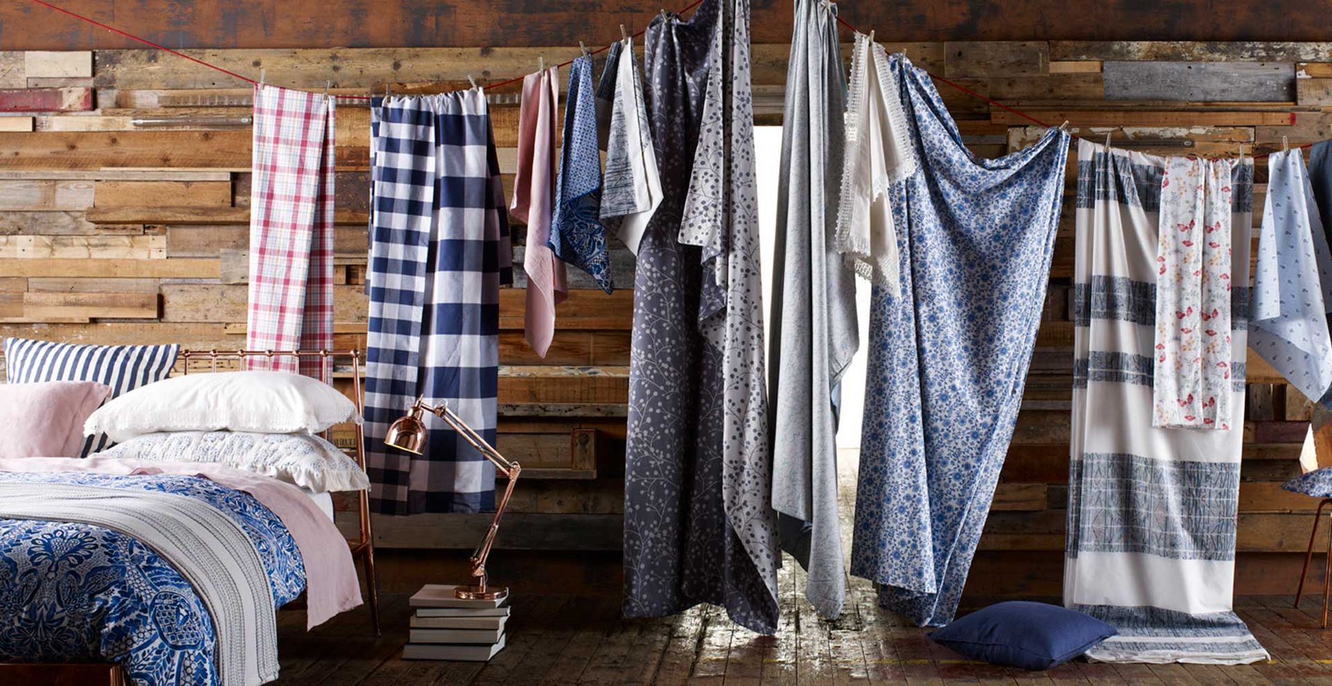 Bedroom with bedding hanging on a washing line to show how to deduce dust