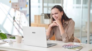 MSI promotional photo of a woman using a Prestige A16 AI+ laptop