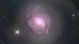 At the heart of the nearby spiral galaxy NGC 1068, researchers found a thriving 'factory' of ghostly particles called neutrinos.