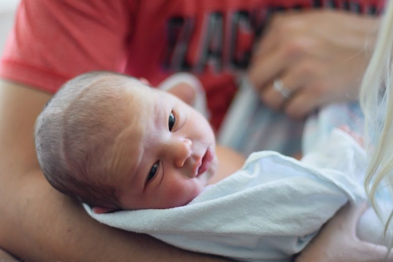 Father holding newborn.