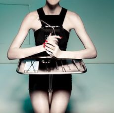 model with tray of plastic surgery tools