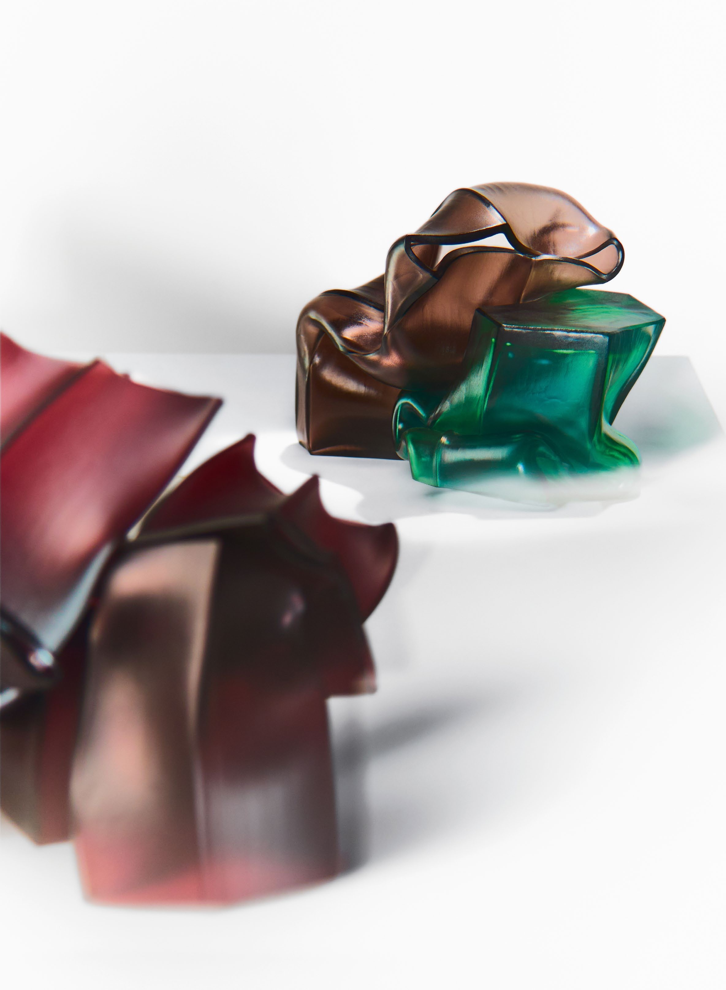 Abstract glass vessels by Liam Fleming, showcasing curvaceous forms in rich colors, reflecting the intersection of art, design, and architecture.