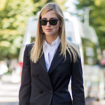 chiara ferragni wearing a double breasted black blazer, white shirt, black sunglasses and sleek straight hair - best hair straighteners