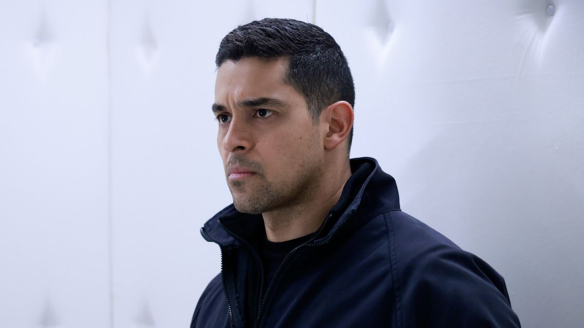 Wilmer Valderrama as Nick Torres standing inside white padded room in NCIS