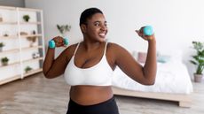 Woman doing dumbbell curls.