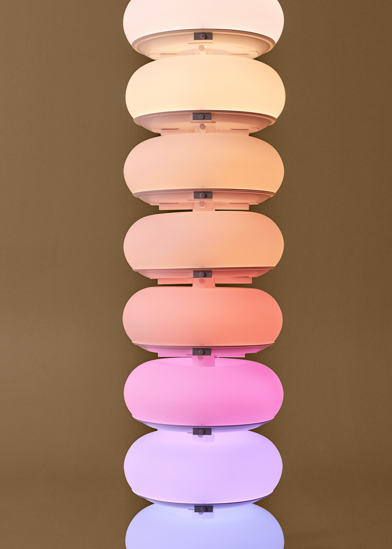 A stack of IKEA VARMBLIXT lamps in different colors