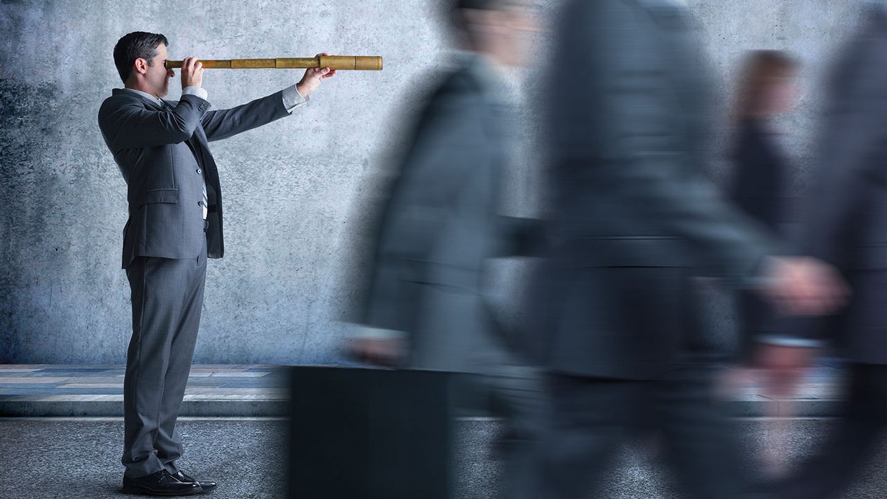 Man in a suit with a telescope