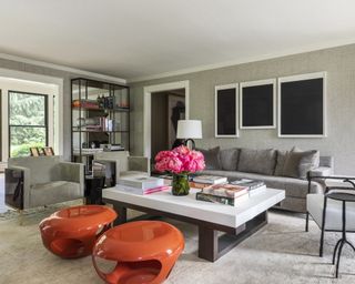 Formal living room ideas with grey textured walls, modern art, grey sofa and armchairs, and red modern stools