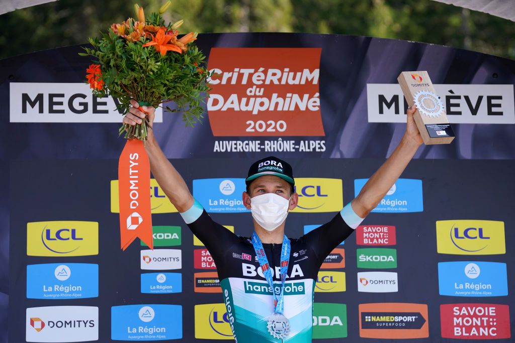MEGEVE FRANCE AUGUST 15 Podium Lennard Kamna of Germany and Team Bora Hansgrohe Celebration Flowers Trophy Medal Covid safety measures during the 72nd Criterium du Dauphine 2020 Stage 4 a 1533km stage from Ugine to Megeve 1458m dauphine Dauphin on August 15 2020 in Megeve France Photo by Eddy LemaistrePool via Getty Images