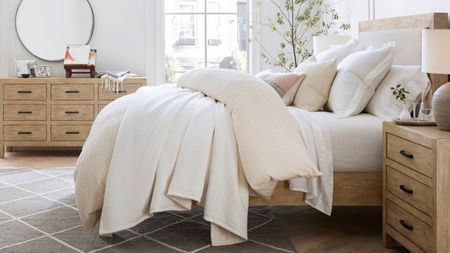 Bedding from the Pottery Barn bedroom collection on a bed.