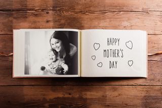 Mothers day composition. Photo album, black-and-white picture. Studio shot on wooden background.